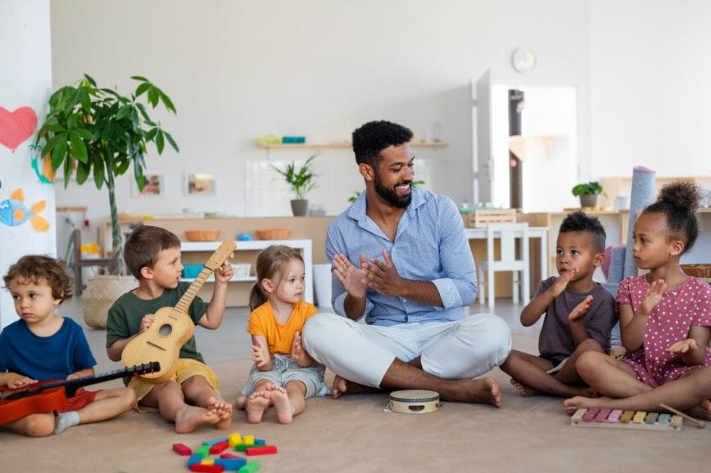 teaching assistant working with kids in a nursery setting